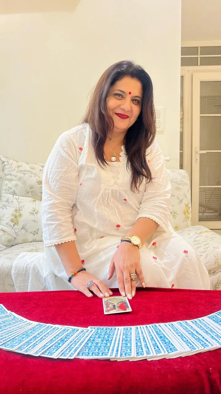 Sapnaa Khemani with a single card turned face up in front of the fanned deck